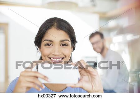 Portrait smiling woman using camera phone View Large Photo Image Stock Photo - Portrait smiling woman using camera phone. Fotosearch