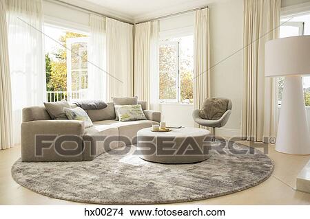 Round carpet under sofa and ottoman in living room View Large Photo Image Picture - Round carpet under sofa and ottoman in living room. Fotosearch