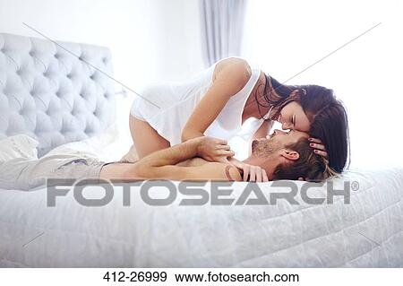 Sexy couple laying on bed View Large Photo Image Stock Photo - Sexy couple laying on bed. Fotosearch