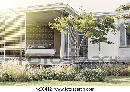 Shutter patio doors open to luxury bedroom View Large Photo Image Stock Image - Shutter patio doors open to luxury bedroom. Fotosearch