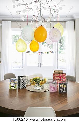Smiley face balloons and Happy Birthday sign hanging over table with cards View Large Photo Image Stock Photography - Smiley face balloons and Happy Birthday sign hanging over table with cards. Fotosearch