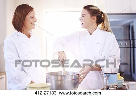 Smiling chefs baking in kitchen View Large Photo Image Stock Image - Smiling chefs baking in kitchen. Fotosearch