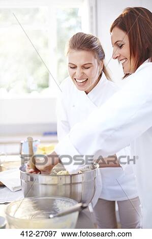Stock Photo - Smiling chefs baking in kitchen. Fotosearch