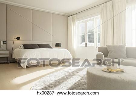 Stock Photo - Sunny bedroom with sitting area. Fotosearch