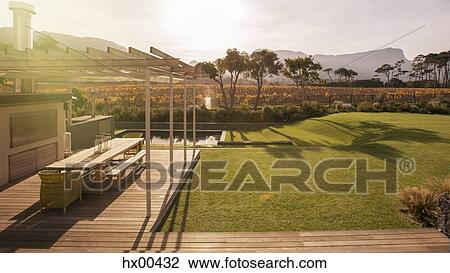Sunny patio and yard overlooking mountains View Large Photo Image Stock Image - Sunny patio and yard overlooking mountains. Fotosearch