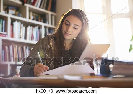 Teenage girl with digital tablet doing homework at desk View Large Photo Image Stock Image - Teenage girl with digital tablet doing homework at desk. Fotosearch