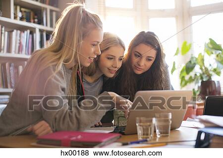 Teenage girls using digital tablet View Large Photo Image Stock Photo - Teenage girls using digital tablet. Fotosearch