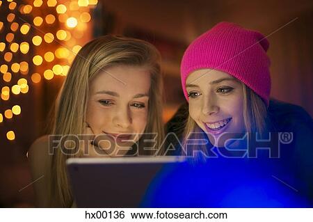 Teenage girls using digital tablet View Large Photo Image Stock Photograph - Teenage girls using digital tablet. Fotosearch