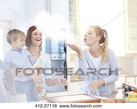 Woman blowing flour baking in kitchen View Large Photo Image Stock Photo - Woman blowing flour baking in kitchen. Fotosearch