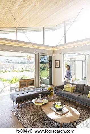 Woman walking into home showcase living room View Large Photo Image Stock Image - Woman walking into home showcase living room. Fotosearch