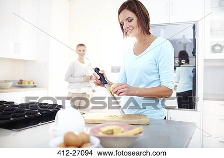 Woman zesting lemon in kitchen View Large Photo Image Picture - Woman zesting lemon in kitchen. Fotosearch