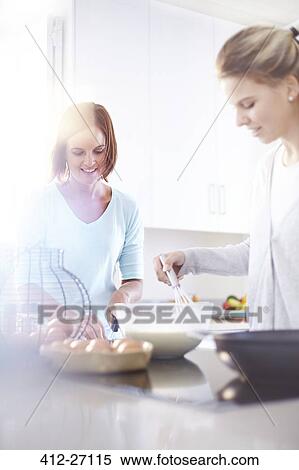 Women baking in sunny kitchen View Large Photo Image Stock Photography - Women baking in sunny kitchen. Fotosearch