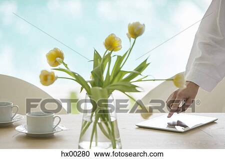 Yellow tulip bouquet on table at poolside View Large Photo Image Stock Image - Yellow tulip bouquet on table at poolside. Fotosearch