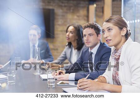 Stock Image - Attentive business people in conference room meeting. Fotosearch