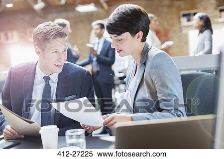 Business people discussing paperwork in office View Large Photo Image Stock Photography - Business people discussing paperwork in office. Fotosearch