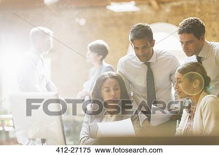 Business people reviewing paperwork in office View Large Photo Image Stock Photography - Business people reviewing paperwork in office. Fotosearch