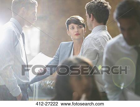 Stock Image - Business people talking in office. Fotosearch