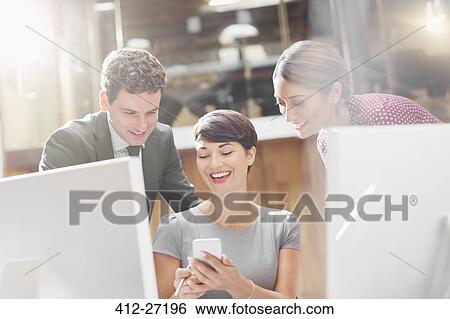 Business people texting with cell phone in office View Large Photo Image Stock Photograph - Business people texting with cell phone in office. Fotosearch