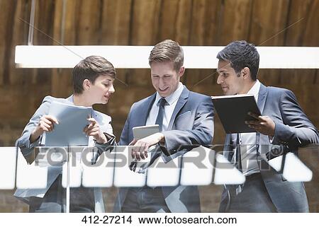 Picture - Business people with digital tablet on office balcony. Fotosearch