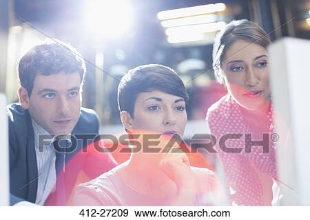 Stock Photo - Business people working at computer in office. Fotosearch