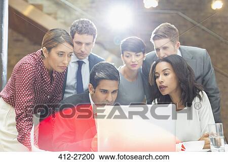 Business people working at laptop in office View Large Photo Image Stock Image - Business people working at laptop in office. Fotosearch