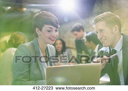 Business people working at laptop in office View Large Photo Image Stock Image - Business people working at laptop in office. Fotosearch
