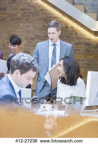 Stock Photograph - Business people working in office. Fotosearch