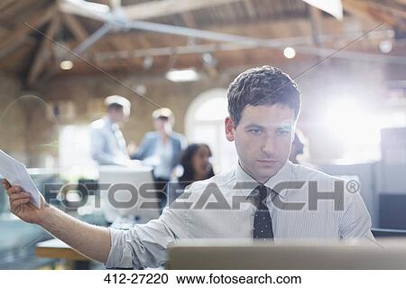 Businessman working at laptop in office View Large Photo Image Stock Image - Businessman working at laptop in office. Fotosearch