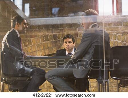Businessmen talking in conference room meeting View Large Photo Image Stock Image - Businessmen talking in conference room meeting. Fotosearch