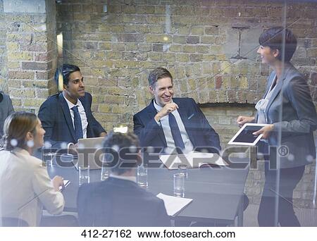Businesswoman leading meeting in conference room View Large Photo Image Stock Image - Businesswoman leading meeting in conference room. Fotosearch