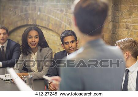 Stock Photography - Businesswoman leading meeting in conference room. Fotosearch
