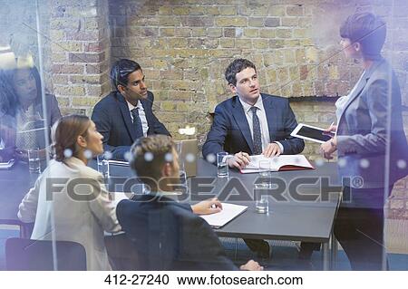Businesswoman with digital tablet leading meeting in conference room View Large Photo Image Stock Image - Businesswoman with digital tablet leading meeting in conference room. Fotosearch