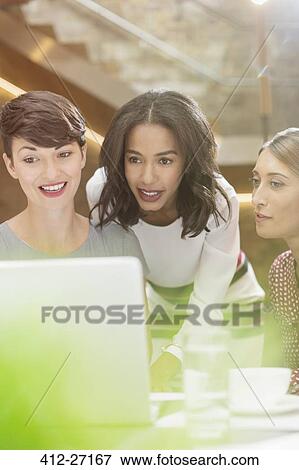 Businesswomen working at laptop in office View Large Photo Image Stock Photo - Businesswomen working at laptop in office. Fotosearch