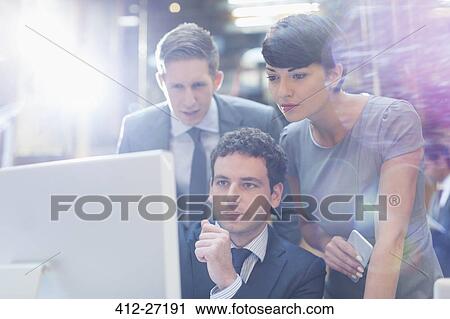 Focused business people working at computer in office View Large Photo Image Stock Image - Focused business people working at computer in office. Fotosearch