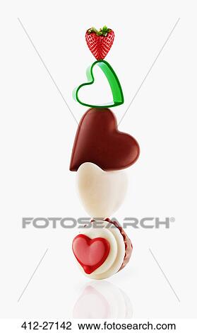 Heart-shaped desserts balancing View Large Photo Image Stock Image - Heart-shaped desserts balancing. Fotosearch
