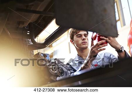 Mechanic working in auto repair shop View Large Photo Image Stock Photo - Mechanic working in auto repair shop. Fotosearch