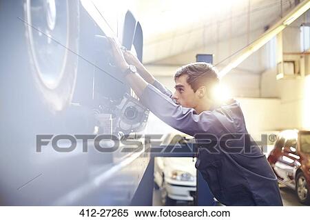Mechanic working on car in auto repair shop View Large Photo Image Stock Photography - Mechanic working on car in auto repair shop. Fotosearch