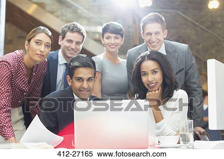 Portrait confident business people at laptop in office View Large Photo Image Stock Photography - Portrait confident business people at laptop in office. Fotosearch