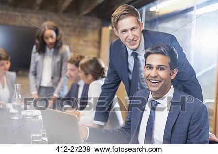 Stock Photo - Portrait confident businessmen in conference room meeting. Fotosearch