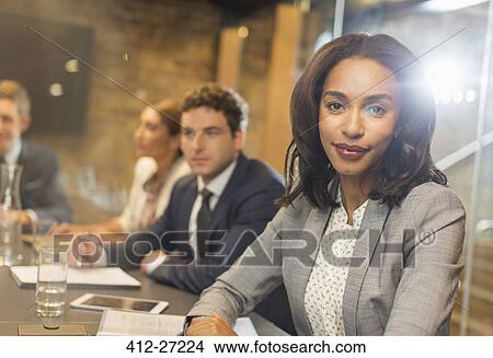Portrait confident businesswoman in conference room meeting View Large Photo Image Picture - Portrait confident businesswoman in conference room meeting. Fotosearch