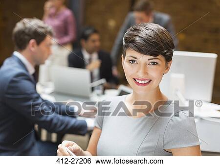 Portrait confident businesswoman in office View Large Photo Image Stock Photograph - Portrait confident businesswoman in office. Fotosearch