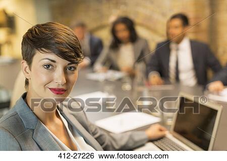 Portrait confident businesswoman with laptop in meeting View Large Photo Image Stock Photograph - Portrait confident businesswoman with laptop in meeting. Fotosearch