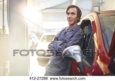Portrait confident mechanic leaning on car in auto repair shop View Large Photo Image Stock Photo - Portrait confident mechanic leaning on car in auto repair shop. Fotosearch