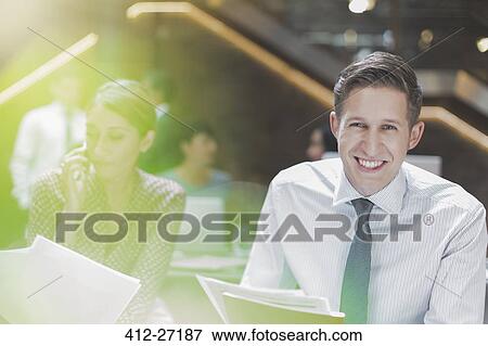 Stock Photo - Portrait smiling businessman in office. Fotosearch