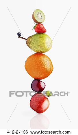 Stacked fruit on white background View Large Photo Image Stock Photograph - Stacked fruit on white background. Fotosearch