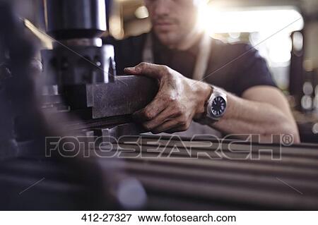 Close up mechanic using machinery in auto repair shop View Large Photo Image Stock Photo - Close up mechanic using machinery in auto repair shop. Fotosearch
