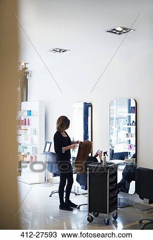 Hairdresser working with customer in hair salon View Large Photo Image Stock Image - Hairdresser working with customer in hair salon. Fotosearch