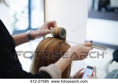 Hairdresser wrapping customer’s hair in curlers in salon View Large Photo Image Stock Photography - Hairdresser wrapping customer’s hair in curlers in salon. Fotosearch
