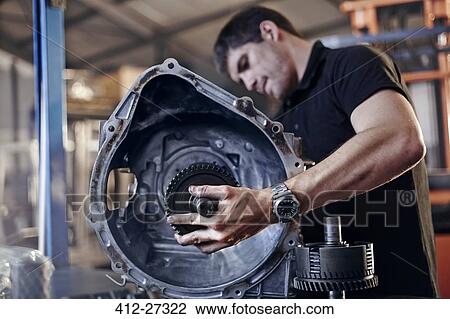 Mechanic fixing part in auto repair shop View Large Photo Image Stock Image - Mechanic fixing part in auto repair shop. Fotosearch