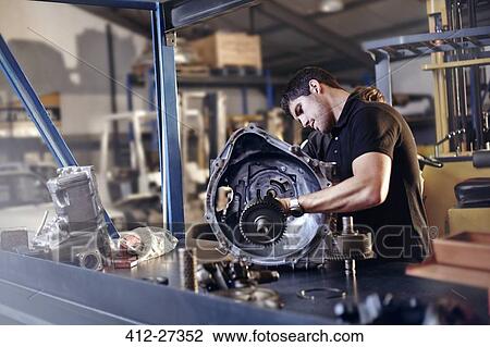Mechanic fixing part in auto repair shop View Large Photo Image Stock Image - Mechanic fixing part in auto repair shop. Fotosearch